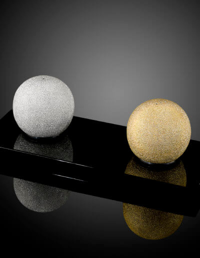 "Orb" hand raised and textured, magnetic salt and pepper shakers. Black crystal magnetic base.